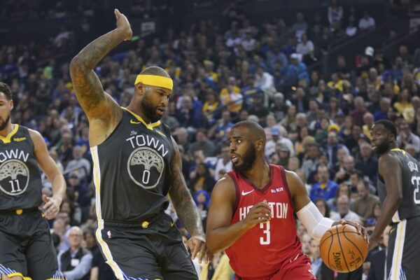 Houston Rockets guard Chris Paul (3) dribbles the basketball against Golden State Warriors center DeMarcus Cousins (0) during the first quarter at Oracle Arena.