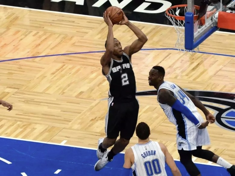 Kawhi Leonard scores during his time with the Spurs.