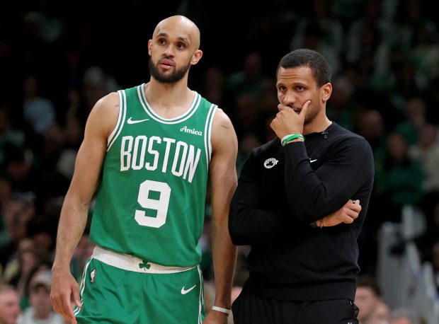 Boston, MA - April 23 - Derrick White #9 of the Boston Celtics talks with head coach Joe Mazzulla during the third quarter of Game 2 of the Eastern Conference Finals at the TD Garden. (Photo By Matt Stone/Boston Herald)