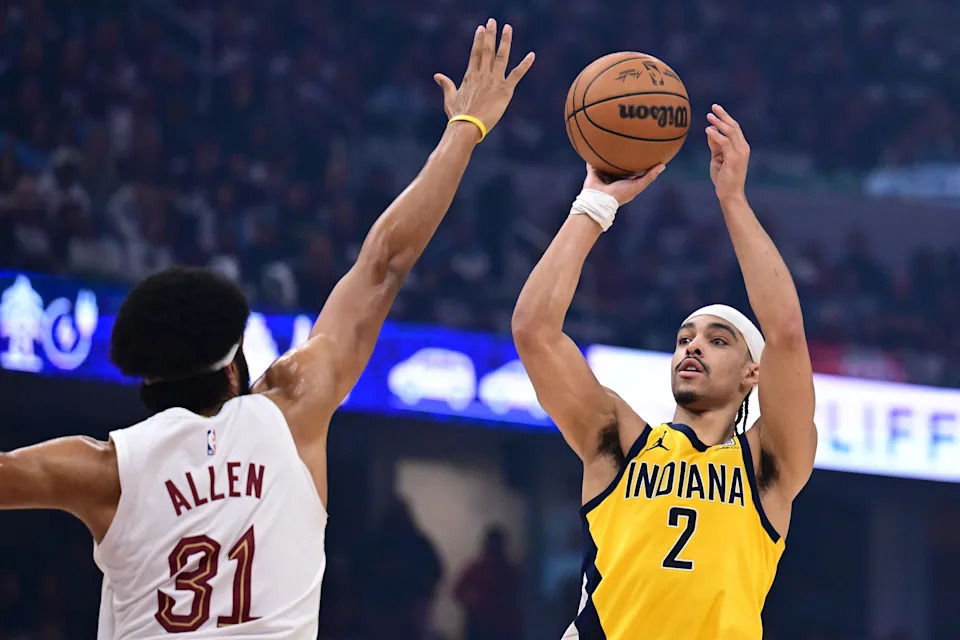 May 4, 2025; Cleveland, Ohio, USA; Indiana Pacers guard Andrew Nembhard (2) shoots over the defense of Cleveland Cavaliers center Jarrett Allen (31) during the first half in game one of the second round for the 2025 NBA Playoffs at Rocket Arena. Mandatory Credit: Ken Blaze-Imagn Images