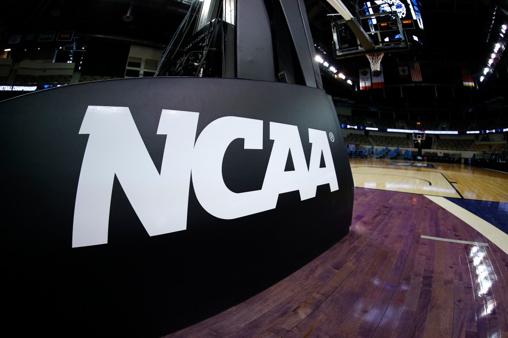 NCAA logo on a basketball court backboard.