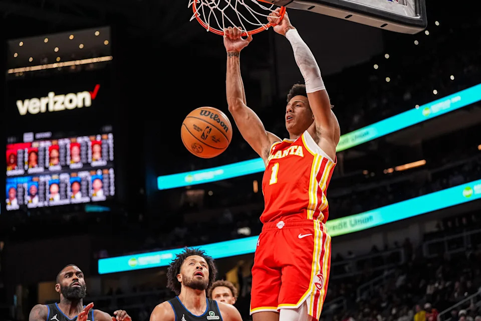 Jan 22, 2025; Atlanta, Georgia, USA; Atlanta Hawks forward Jalen Johnson (1) dunks the ball behind Detroit Pistons guard Cade Cunningham (2) during the second half at State Farm Arena. Mandatory Credit: Dale Zanine-Imagn Images