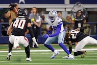 Dallas Cowboys wide receiver Ryan Flournoy (19) slips a tackle from Atlanta Falcons...