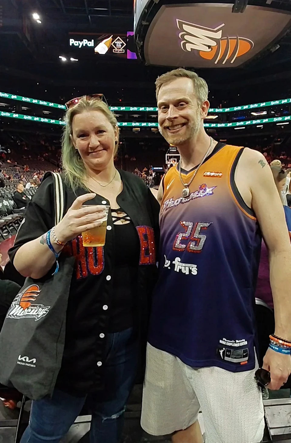 Phoenix Mercury fans Veronica Philpot and Kevin Arnett have become fixtures at Mercury games due to their sparkly attire that's crafted by Arnett himself.