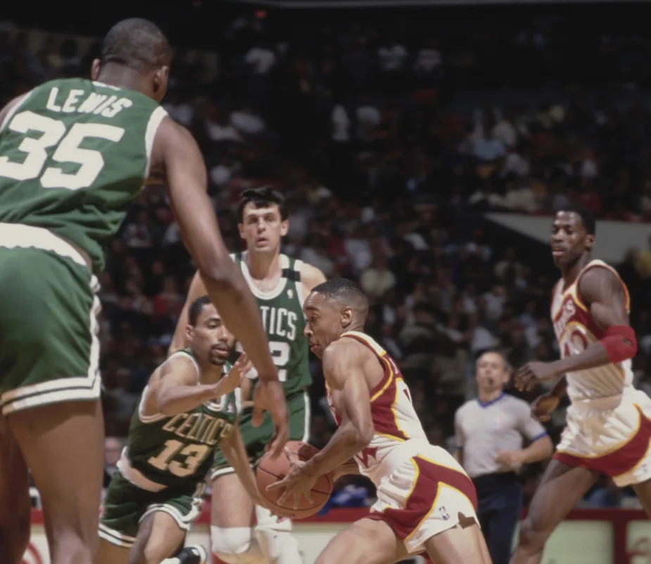 Spud Webb#4, Point Guard for the Atlanta Hawks dribbles the basketball past #13 Charles Smith of the Boston Celtics during their NBA Central Division basketball game on 13th March 1990 at the Omni arena in Atlanta, Georgia, United States, United States. The Celtics won the game 112 - 100. (Photo by Tony Smith/Allsport/ Getty Images)