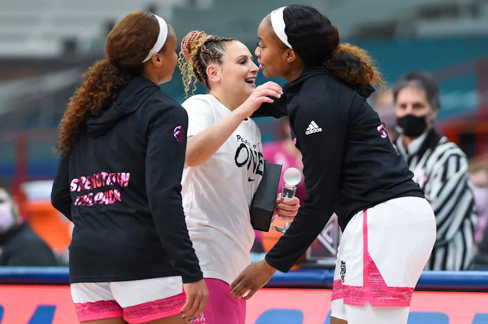 Feb 28, 2021; Syracuse, New York, USA; NC State Wolfpack players present an award to Syracuse Orange guard Tiana Mangakahia (center) prior to their Play 4 Kay game at the Carrier Dome. Mandatory Credit: Rich Barnes-USA TODAY SportsGetty Images.
