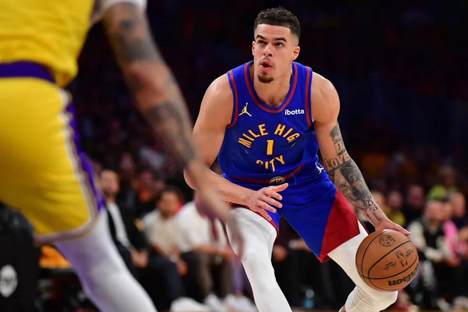 Denver Nuggets forward Michael Porter Jr. controls the ball against the Los Angeles Lakers.© Gary A. Vasquez-Imagn Images