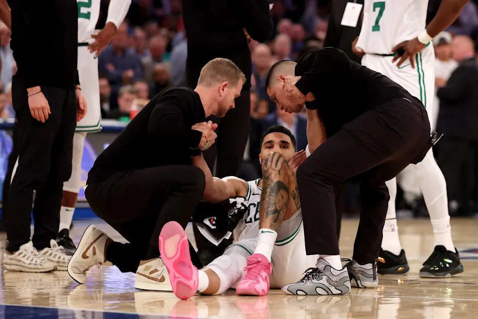 NEW YORK, NEW YORK - MAY 12: Jayson Tatum #0 of the Boston Celtics is assisted on court after being injured against the New York Knicks during the fourth quarter in Game Four of the Eastern Conference Second Round NBA Playoffs at Madison Square Garden on May 12, 2025 in New York City. NOTE TO USER: User expressly acknowledges and agrees that, by downloading and or using this photograph, User is consenting to the terms and conditions of the Getty Images License Agreement. (Photo by Elsa/Getty Images)
