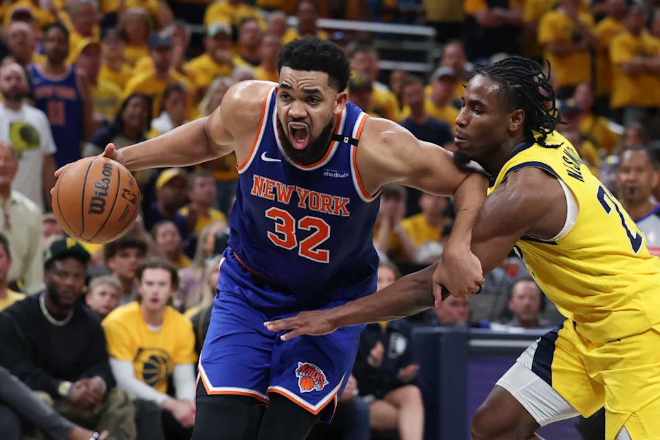 May 31, 2025; Indianapolis, Indiana, USA; New York Knicks center Karl-Anthony Towns (32) drives to the basket against Indiana Pacers guard Andrew Nembhard (2) in the third quarter during game six of the eastern conference finals for the 2025 NBA Playoffs at Gainbridge Fieldhouse. Mandatory Credit: Trevor Ruszkowski-Imagn Images