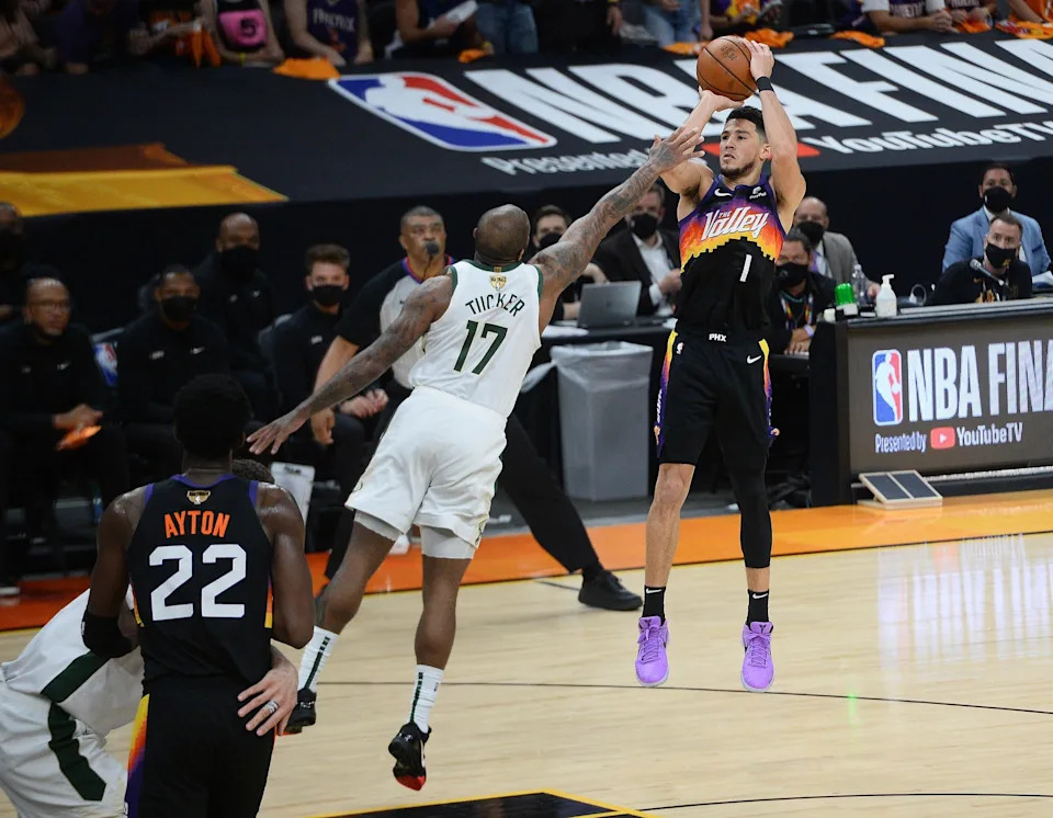 Phoenix Suns guard Devin Booker (1) shoots against Milwaukee Bucks forward P.J. Tucker (17) during the second half in game two of the 2021 NBA Finals at Phoenix Suns Arena on July 8, 2021.