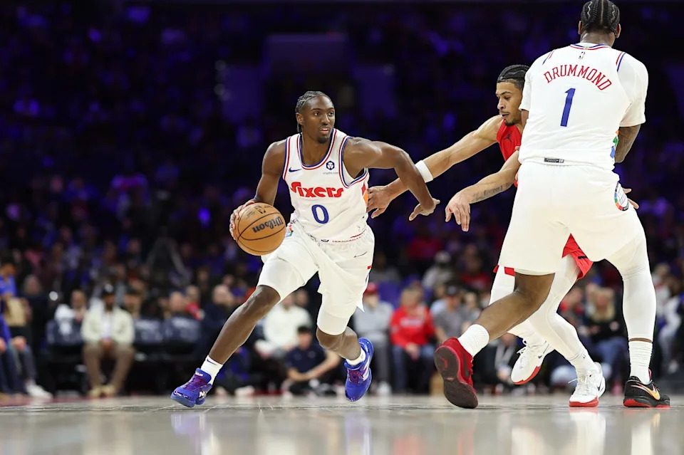 Mar 3, 2025; Philadelphia, Pennsylvania, USA; Philadelphia 76ers guard Tyrese Maxey (0) dribbles past Portland Trail Blazers forward Toumani Camara (33) during the first quarter at Wells Fargo Center. Mandatory Credit: Bill Streicher-Imagn Images