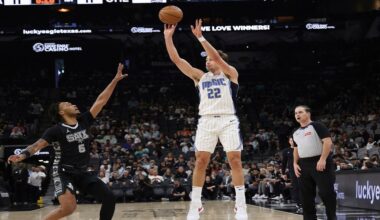 Orlando Magic forward Franz Wagner (22) shoots a three-point shot against San Antonio Spurs guard Stephon Castle (5) during the first half of an NBA basketball game in San Antonio, Tuesday, April 1, 2025. (AP Photo/Kin Man Hui)