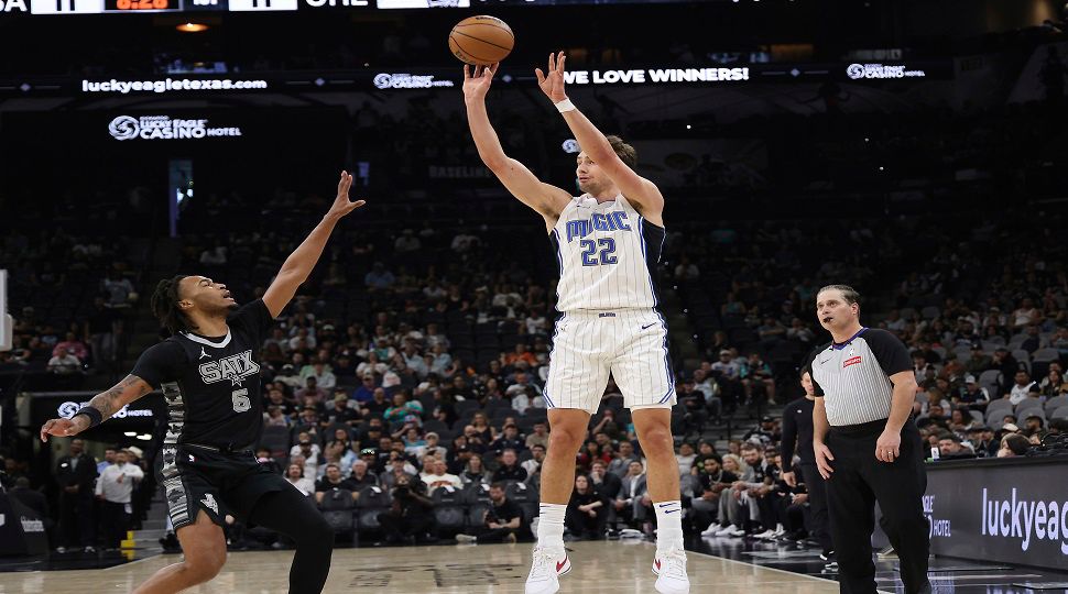 Orlando Magic forward Franz Wagner (22) shoots a three-point shot against San Antonio Spurs guard Stephon Castle (5) during the first half of an NBA basketball game in San Antonio, Tuesday, April 1, 2025. (AP Photo/Kin Man Hui)