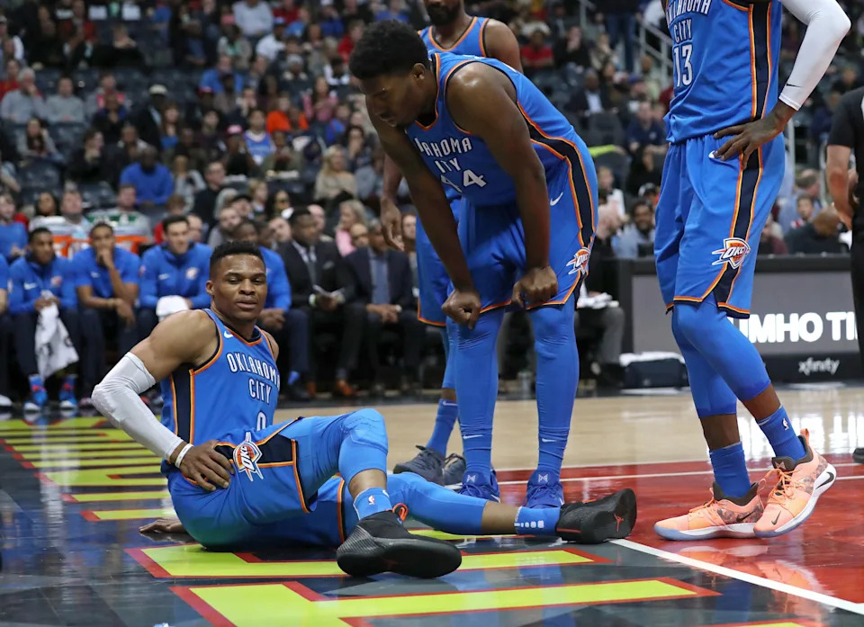 Mar 13, 2018; Atlanta, GA, USA; Oklahoma City Thunder guard Russell Westbrook (0) grabs his hip after an injury following a play against the Atlanta Hawks as Oklahoma City Thunder center Dakari Johnson (44) watches during the first quarter at Philips Arena. Mandatory Credit: Jason Getz-USA TODAY Sports