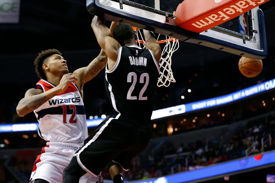 Apr 6, 2016; Washington, DC, USA; Brooklyn Nets guard Markel Brown (22) is fouled by Washington Wizards forward Kelly Oubre Jr. (12) while attempting to dunk the ball in the fourth quarter at Verizon Center. The Wizards won 121-103. Mandatory Credit: Geoff Burke-USA TODAY Sports
