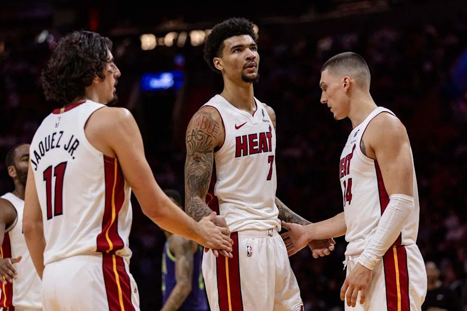 Miami Heat center Kel'el Ware (7) interacts with teammates Jaime Jaquez Jr. (11) and Tyler Herro (14) during the second half of an NBA game against the New Orleans Pelicans at Kaseya Center on January 1, 2025, in Miami.