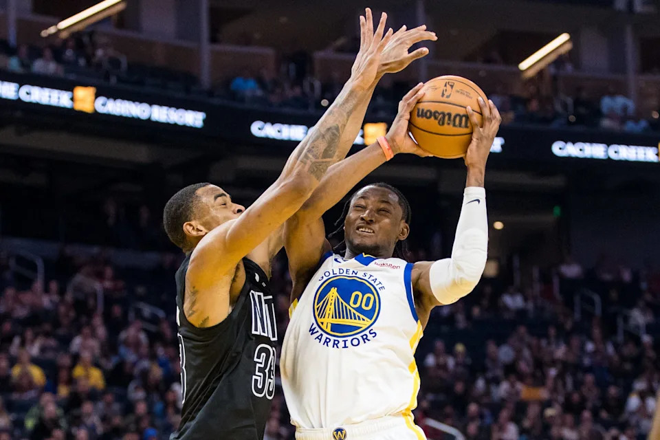 Jan 22, 2023; San Francisco, California, USA; Brooklyn Nets center Nic Claxton (33) fouls Golden State Warriors forward Jonathan Kuminga (00) during the first half at Chase Center. Mandatory Credit: John Hefti-USA TODAY Sports