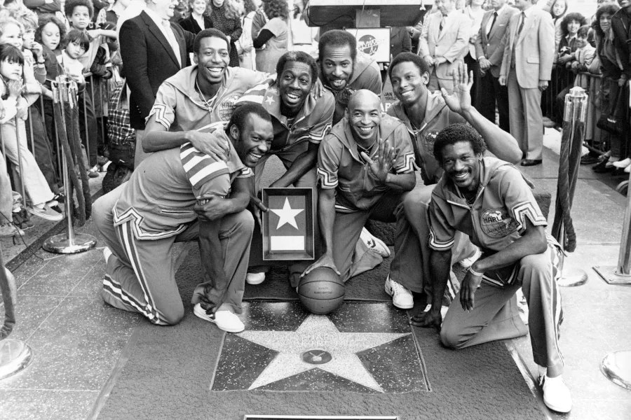 FILE - The Harlem Globetrotters are honored with a star in the Hollywood Walk of Fame in Los Angeles, on Jan. 19, 1982. The Globetrotters became the first athletic team to be honored with a star on the sidewalk. From left are, Billy Hobley, Dallas Thornton, Hubert "Geese" Ausbie, Nate Branch, Fred "Curly" Neal, Robert Paige and Larry “Gator” Rivers. Rivers, who helped integrate high school basketball in Georgia before playing for the Harlem Globetrotters and becoming a county commissioner in his native Savannah, died Saturday, April 29, 2023, at age 73. (AP Photo/Lennox McLendon, File)
