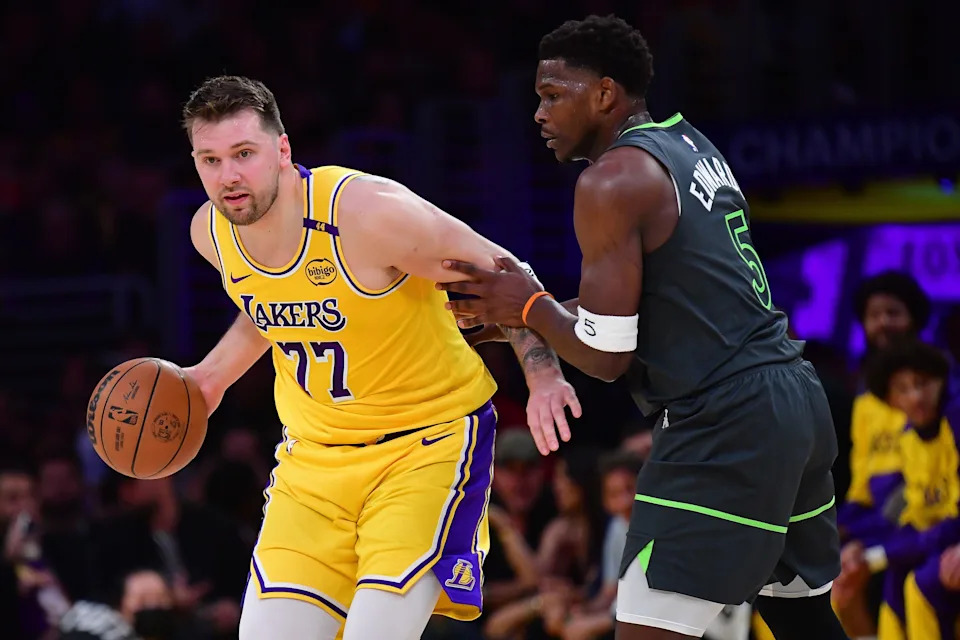 Apr 30, 2025; Los Angeles, California, USA; Los Angeles Lakers guard Luka Doncic (77) controls the ball against Minnesota Timberwolves guard Anthony Edwards (5) during the first half in game five of first round for the 2025 NBA Playoffs at Crypto.com Arena. Mandatory Credit: Gary A. Vasquez-Imagn Images