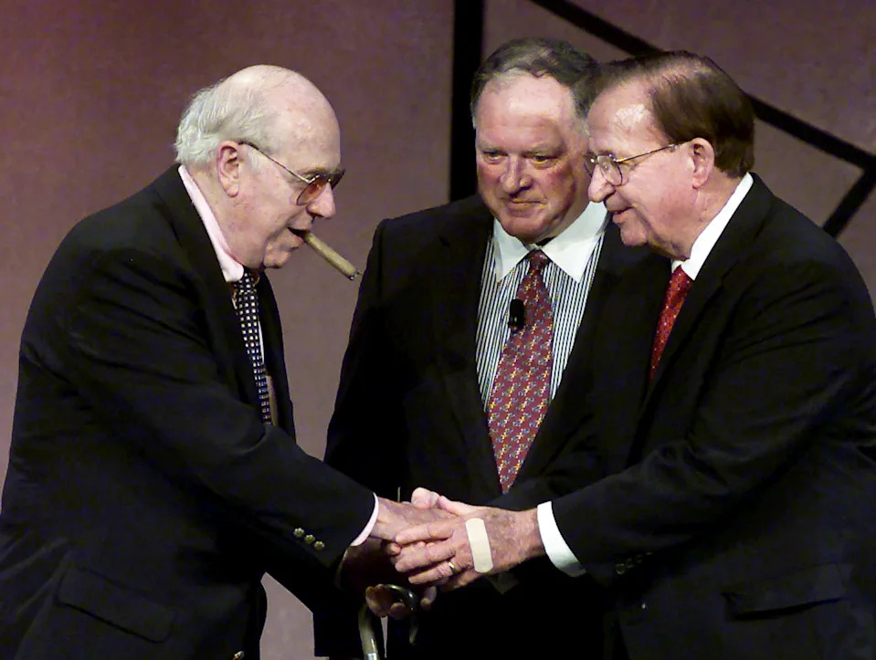 Morgan Wooten (R), the high-school basketball coach with the most wins in U.S. history, is inducted into the Basketball Hall of Fame by Boston Celtics' legendary coach Red Auerbach (L) and Hall of Fame Chairman of the Board Dave Gavitt (C) during ceremonies in Springfield, Massachusetts, in this October 13, 2000 file photo. Auerbach, who led the Celtics to nine NBA championships in the 1950s and 1960s, died October 28, 2006 at the age of 89 REUTERS/Jim Bourg/Files (UNITED STATES)