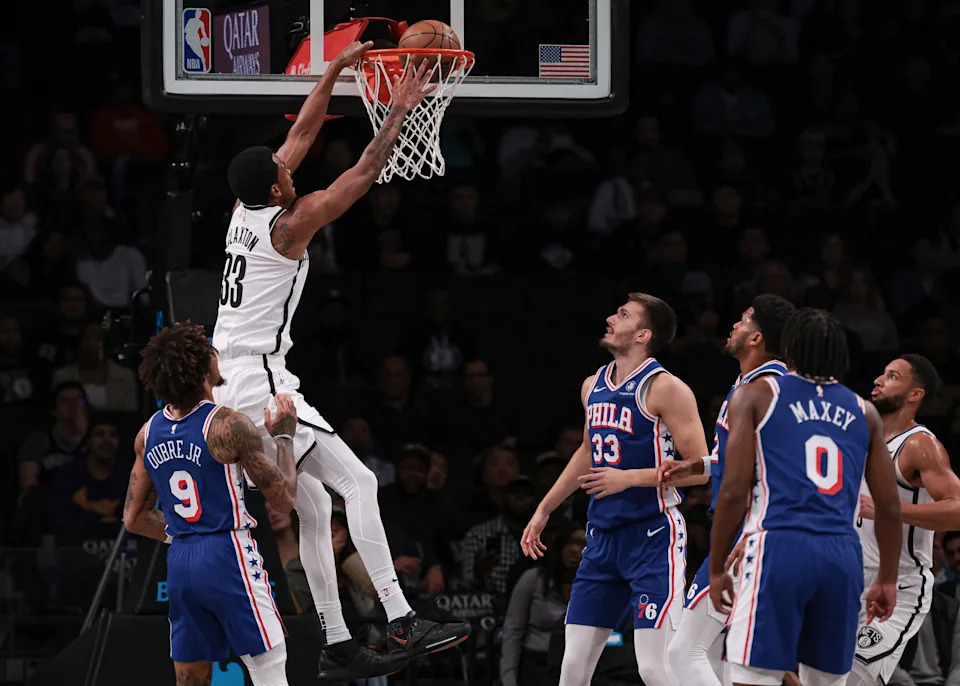 Oct 16, 2023; Brooklyn, New York, USA; Brooklyn Nets center Nic Claxton (33) dunks the ball during the first quarter in front of Philadelphia 76ers guard Kelly Oubre Jr. (9) and forward Filip Petrusev (33) at Barclays Center. Mandatory Credit: Vincent Carchietta-USA TODAY Sports