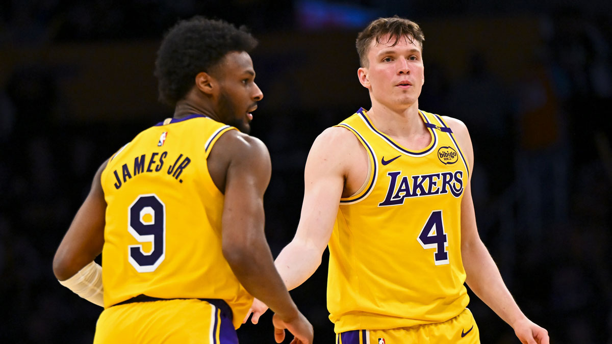 Los Angeles Lakers guard Dalton Knecht (4) fives guard Bronny James (9) after scoring against the Milwaukee Bucks during the second half at Crypto.com Arena. 