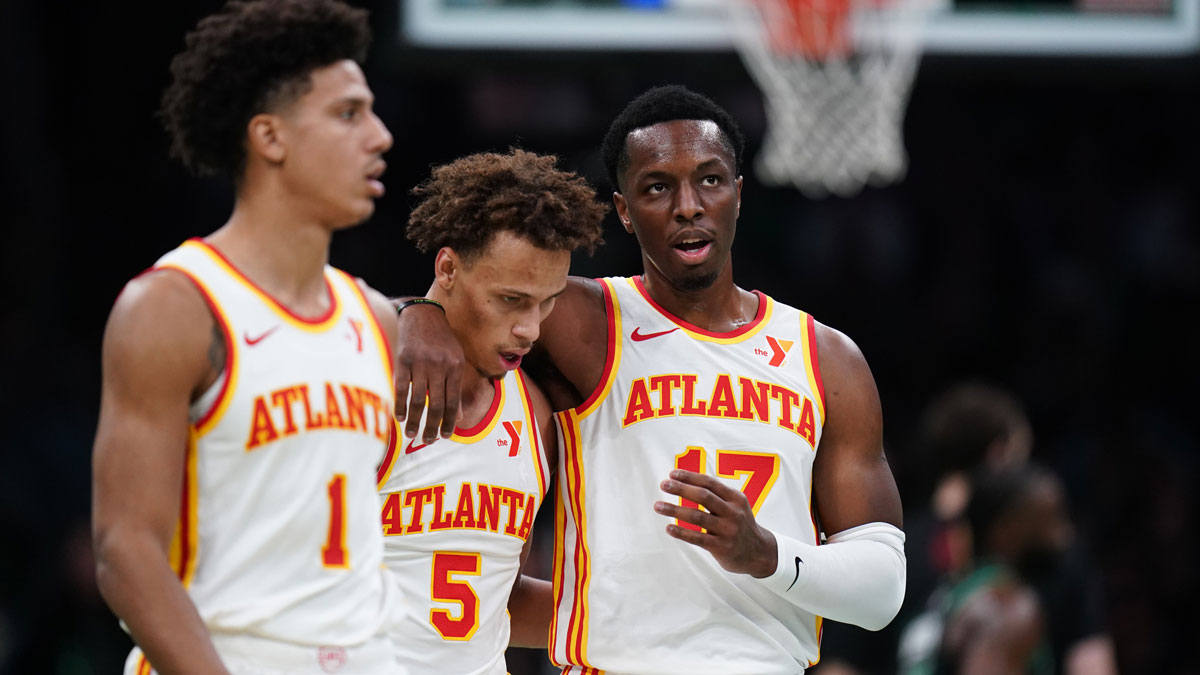 Atlanta Hawks forward Onyeka Okongwu (17), guard Dyson Daniels (5) and forward Jalen Johnson (1) walk to the bench during a break in the action against the Boston Celtics in the second half at TD Garden. 