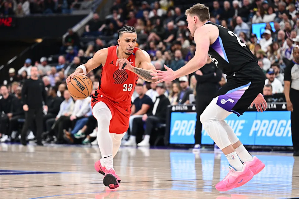 Apr 9, 2025; Salt Lake City, Utah, USA; Portland Trail Blazers forward Toumani Camara (33) controls the ball while being guarded by Utah Jazz center Micah Potter (25) in the second half at Delta Center. Mandatory Credit: Jamie Sabau-Imagn Images