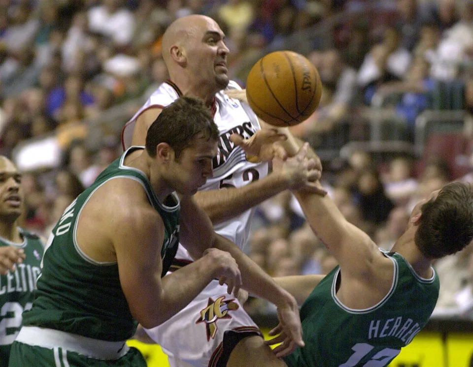 9 Apr 2001: Matt Geiger #52 of the Philadelphia 76ers loses the ball as he drives through the defense of Vitaly Potpenko #52 and Chris Herren #12 of the Boston Celtics as the 76ers defeated the Celtics 108-95 at the First Union Center in Philadelphia, Pennsylvania. < > Mandatory Credit: Doug Pensinger/ALLSPORT. NOTE TO USER: It is expressly understood that the only rights Allsport are offering to license in this Photograph are one-time, non-exclusive editorial rights. No advertising or commercial uses of any kind may be made of Allsport photos. User acknowledges that it is aware that Allsport is an editorial sports agency and that NO RELEASES OF ANY TYPE ARE OBTAINED from the subjects contained in the photographs.