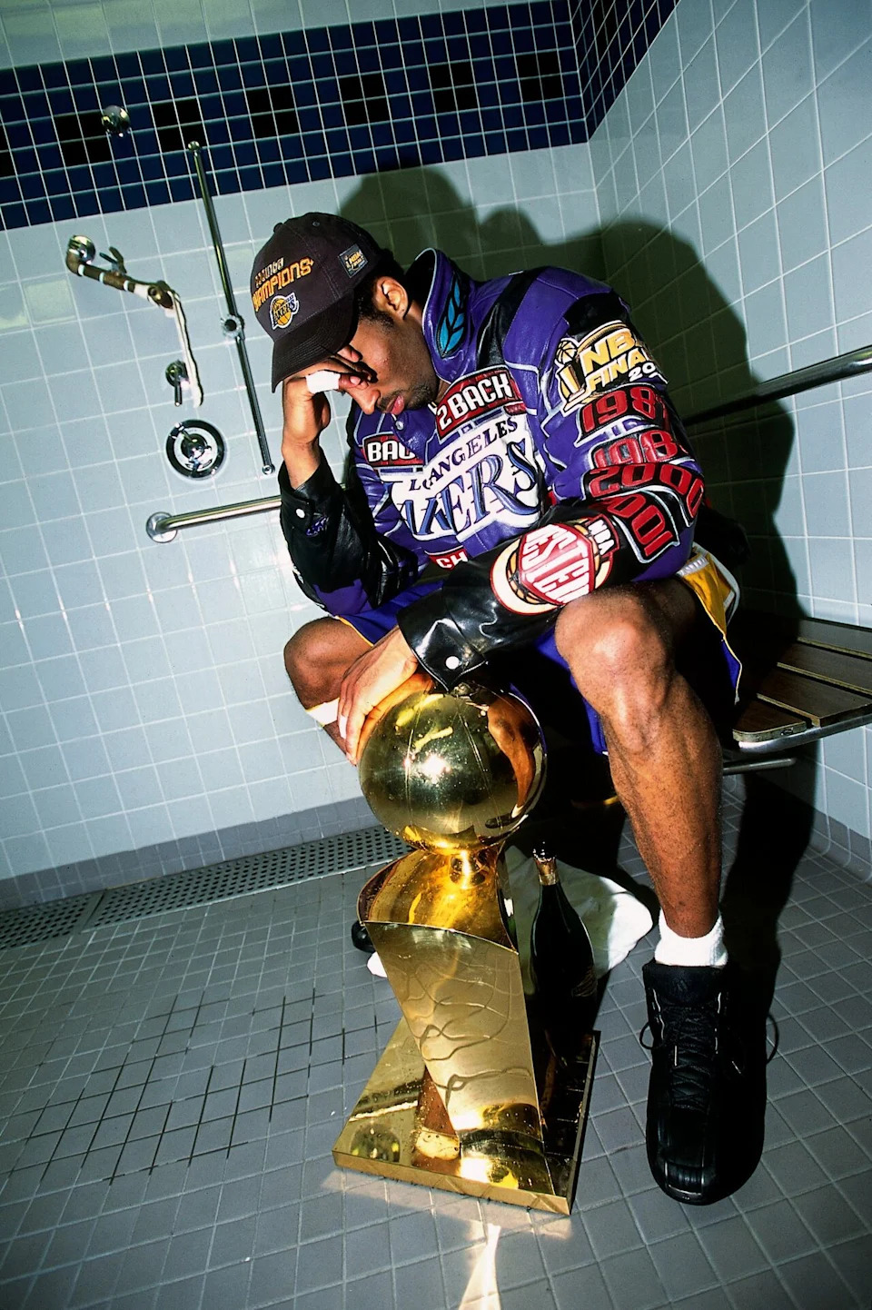 Kobe Bryant poses with the Larry O'Brien Championship Trophy after the Los Angeles Lakers won the 2001 NBA Finals against the Philadelphia 76ers on June 15, 2001.
