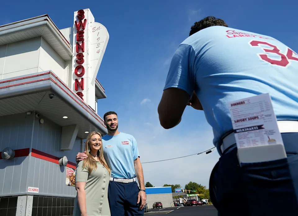 Melissa Sweeten, a fourth grade teacher at Leggett CLC, has her picture taken with Cleveland Cavaliers’ Larry Nance Jr. at the Swensons Drive-In on Hawkins Ave., Sept. 13, 2025, in Akron, Ohio.