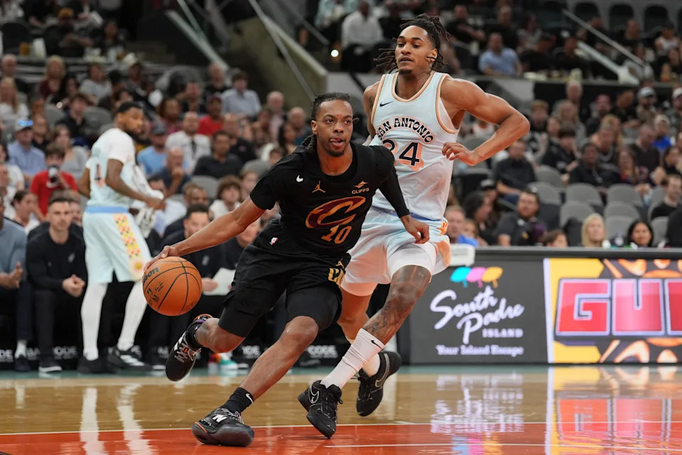 Apr 4, 2025; San Antonio, Texas, USA; Cleveland Cavaliers guard Darius Garland (10) drives past San Antonio Spurs guard Devin Vassell (24) in the first half at Frost Bank Center. Mandatory Credit: Daniel Dunn-Imagn Images