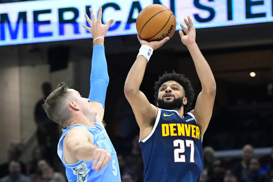 Dec 5, 2024; Cleveland, Ohio, USA; Denver Nuggets guard Jamal Murray (27) shoots beside Cleveland Cavaliers guard Sam Merrill (5) in the second quarter at Rocket Mortgage FieldHouse. Mandatory Credit: David Richard-Imagn Images