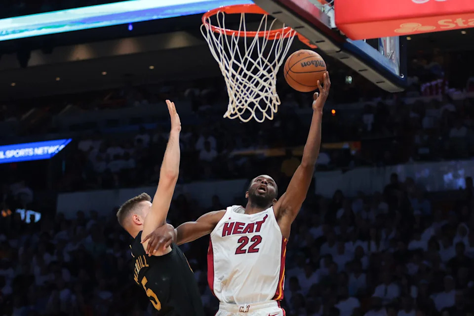 Apr 26, 2025; Miami, Florida, USA;Miami Heat forward Andrew Wiggins (22) drives to the basket against Cleveland Cavaliers guard Sam Merrill (5) in the third quarter during game three for the first round of the 2025 NBA Playoffs at Kaseya Center. Mandatory Credit: Sam Navarro-Imagn Images