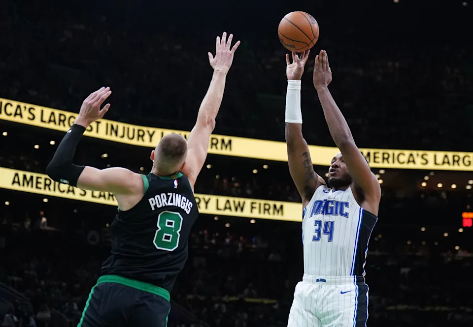 Apr 29, 2025; Boston, Massachusetts, USA; Orlando Magic center Wendell Carter Jr. (34) shoots the ball against Boston Celtics center Kristaps Porzingis (8) in the second quarter during game five of first round for the 2025 NBA Playoffs at TD Garden. Mandatory Credit: David Butler II-Imagn Images