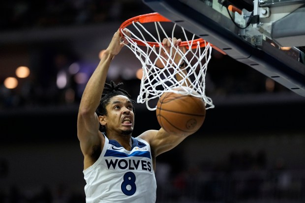 Minnesota Timberwolves forward Josh Minott dunks the ball during the second half of an NBA preseason basketball game against the Philadelphia 76ers, Friday, Oct. 11, 2024, in Des Moines, Iowa. (AP Photo/Charlie Neibergall)