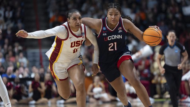 UConn forward Sarah Strong (21) drives the ball past Southern California guard Kennedy Smith (11) during the second half in the Elite Eight of the NCAA college basketball tournament Monday, March 31, 2025, in Spokane, Wash. (AP Photo/Jenny Kane)