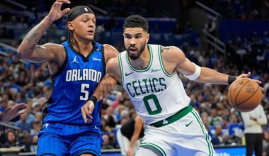 Boston Celtics forward Jayson Tatum (0) tries to get past Orlando Magic forward Paolo Banchero (5) during the first half in game 3 of a first-round NBA playoff basketball series,, Friday, April 25, 2025, in Orlando, Fla. (AP Photo/John Raoux)