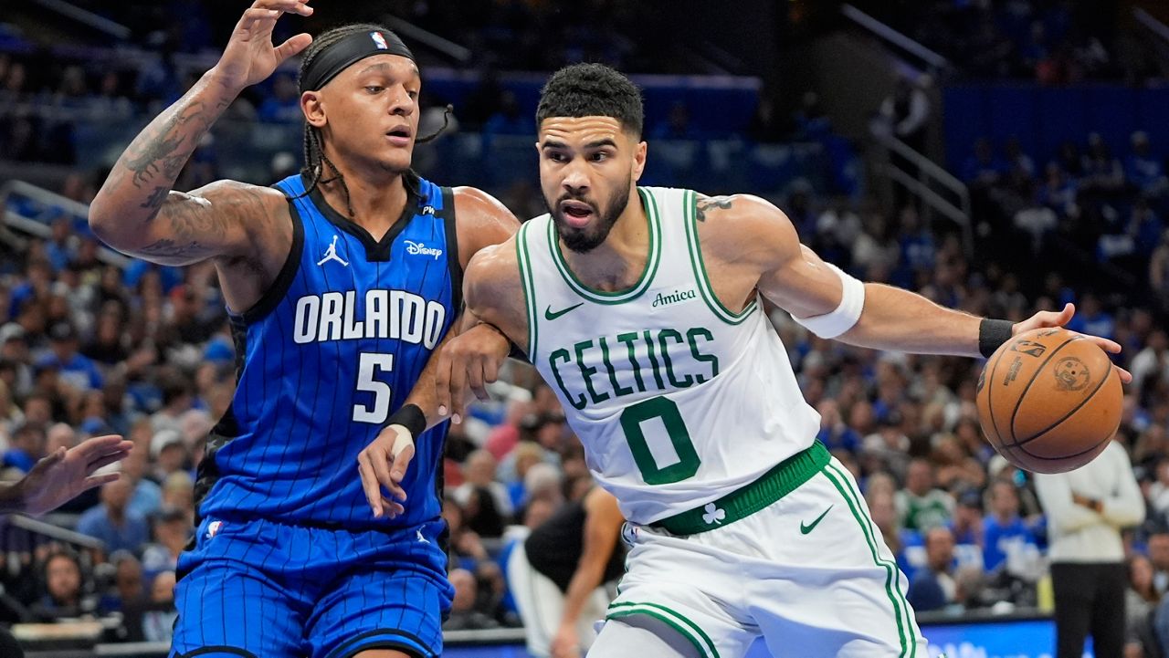 Boston Celtics forward Jayson Tatum (0) tries to get past Orlando Magic forward Paolo Banchero (5) during the first half in game 3 of a first-round NBA playoff basketball series,, Friday, April 25, 2025, in Orlando, Fla. (AP Photo/John Raoux)