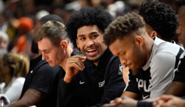 San Antonio Spurs guard Dylan Harper looks on from the bench during the first half of an NBA summer league basketball game against the Philadelphia 76ers, July 10, 2025, in Las Vegas. (AP Photo/David Becker)