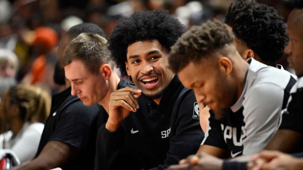 San Antonio Spurs guard Dylan Harper looks on from the bench during the first half of an NBA summer league basketball game against the Philadelphia 76ers, July 10, 2025, in Las Vegas. (AP Photo/David Becker)