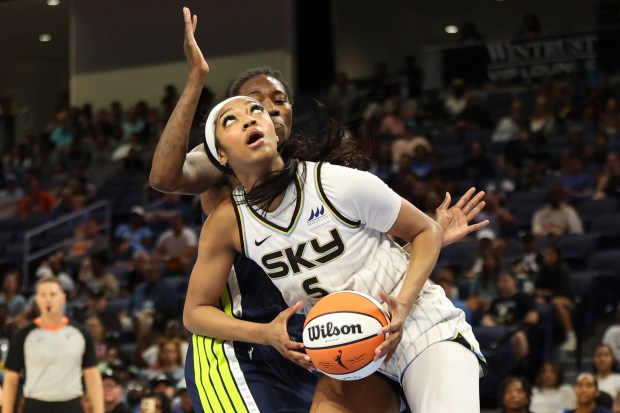 Chicago Sky forward Angel Reese (5) tries to get past...
