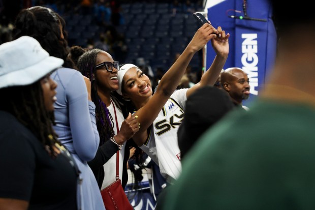 Chicago Sky forward Angel Reese takes a selfie with a...