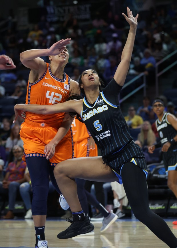 Chicago Sky forward Angel Reese looks for position while battling...