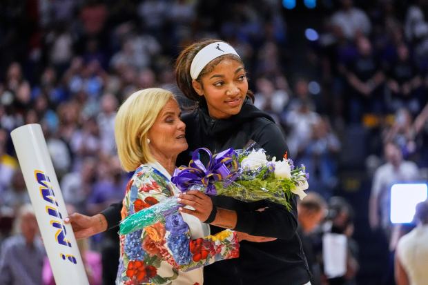 Sky forward Angel Reese hugs her former coach, LSU's Kim...