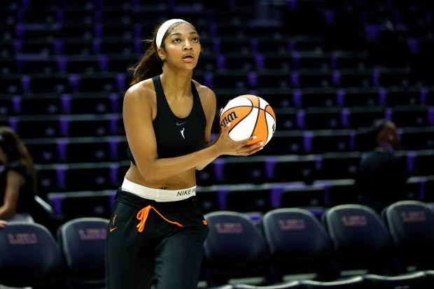 The Sky's Angel Reese warms before a preseason game against...