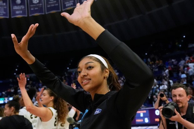 Sky forward Angel Reese responds to the crowd after an...