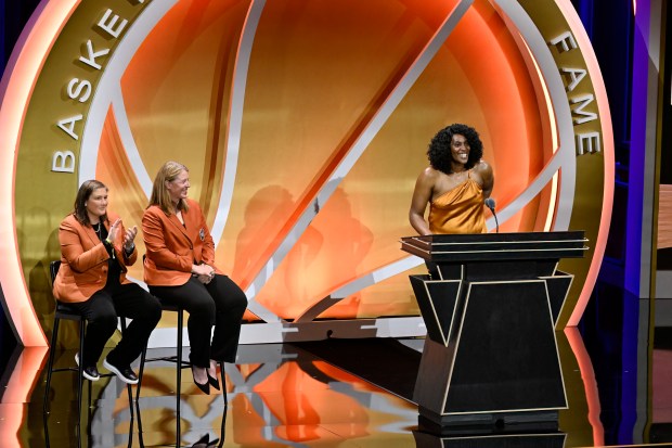 Sylvia Fowles, right, smiles during her enshrinement in the Basketball Hall of Fame as presenters Lindsay Whalen, left, and Katie Smith react Saturday, Sept. 6, 2025, in Springfield, Mass. (Jessica Hill/AP)