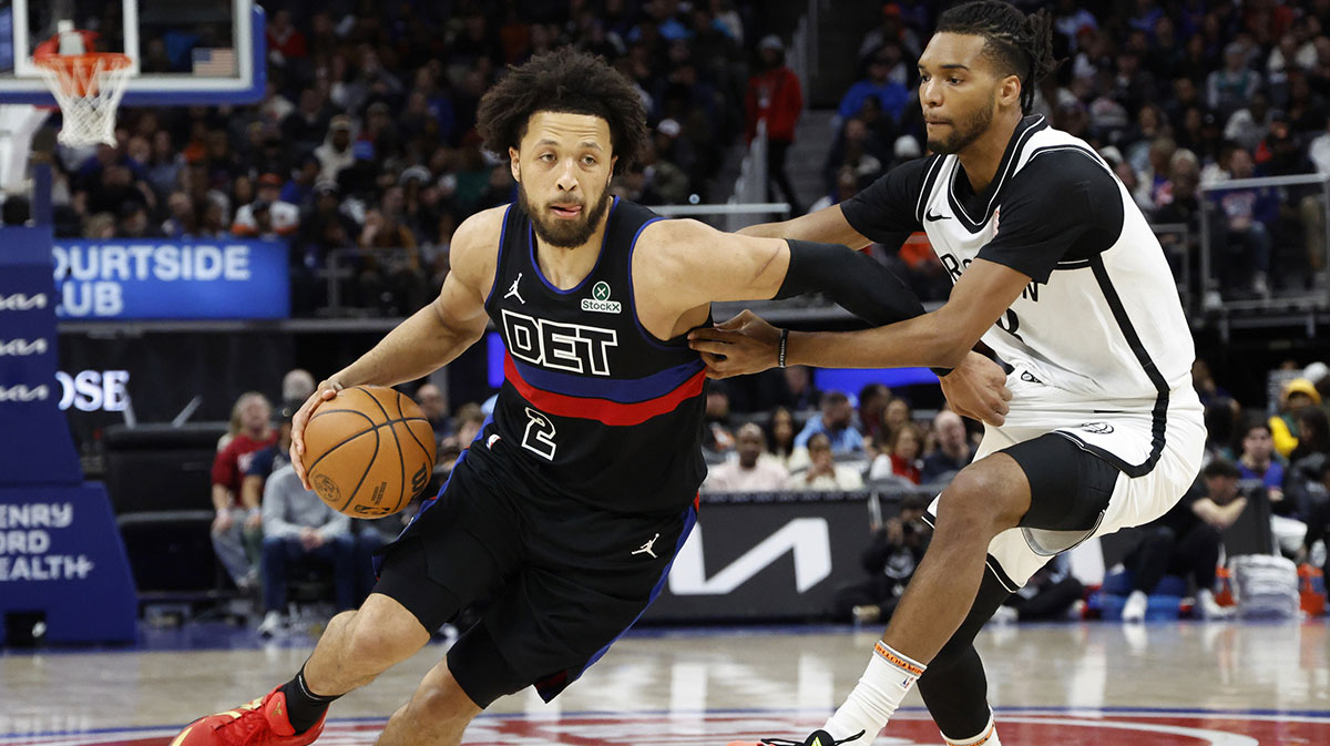 Detroit Pistons guard Cade Cunningham (2) dribbles defended by Brooklyn Nets forward Ziaire Williams (8) in the second half at Little Caesars Arena.