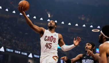 Cleveland Cavaliers guard Donovan Mitchell (45) goes to the basket past Orlando Magic center Wendell Carter Jr. (34) in the first half of an NBA basketball game Sunday, March 16, 2025, in Cleveland. (AP Photo/Sue Ogrocki)